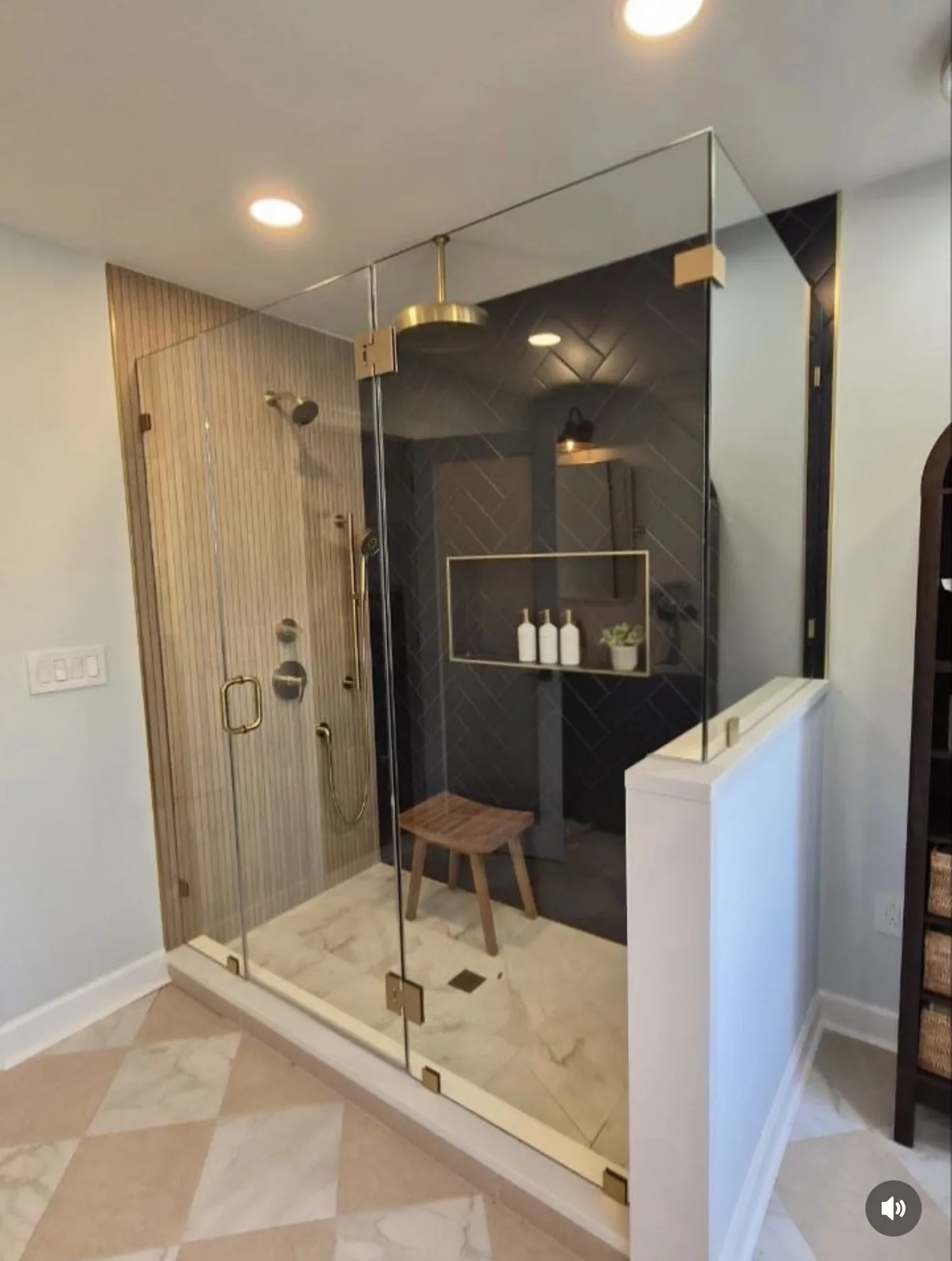 Shower room with navy herringbone tile, brass fixtures and a timber bench