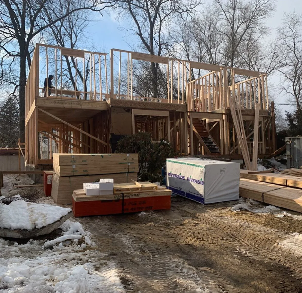 Second story addition framed over an existing house with the rear deck taking shape