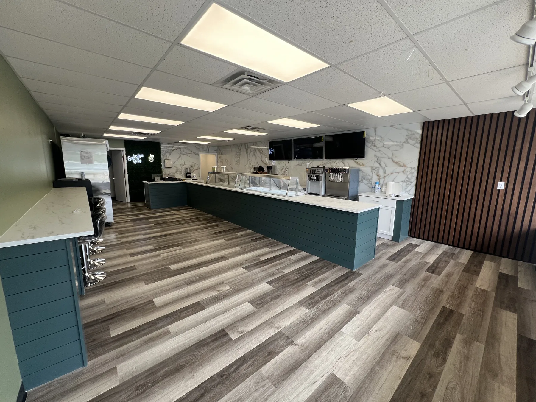 Renovated commercial office interior with a service counter and plank flooring