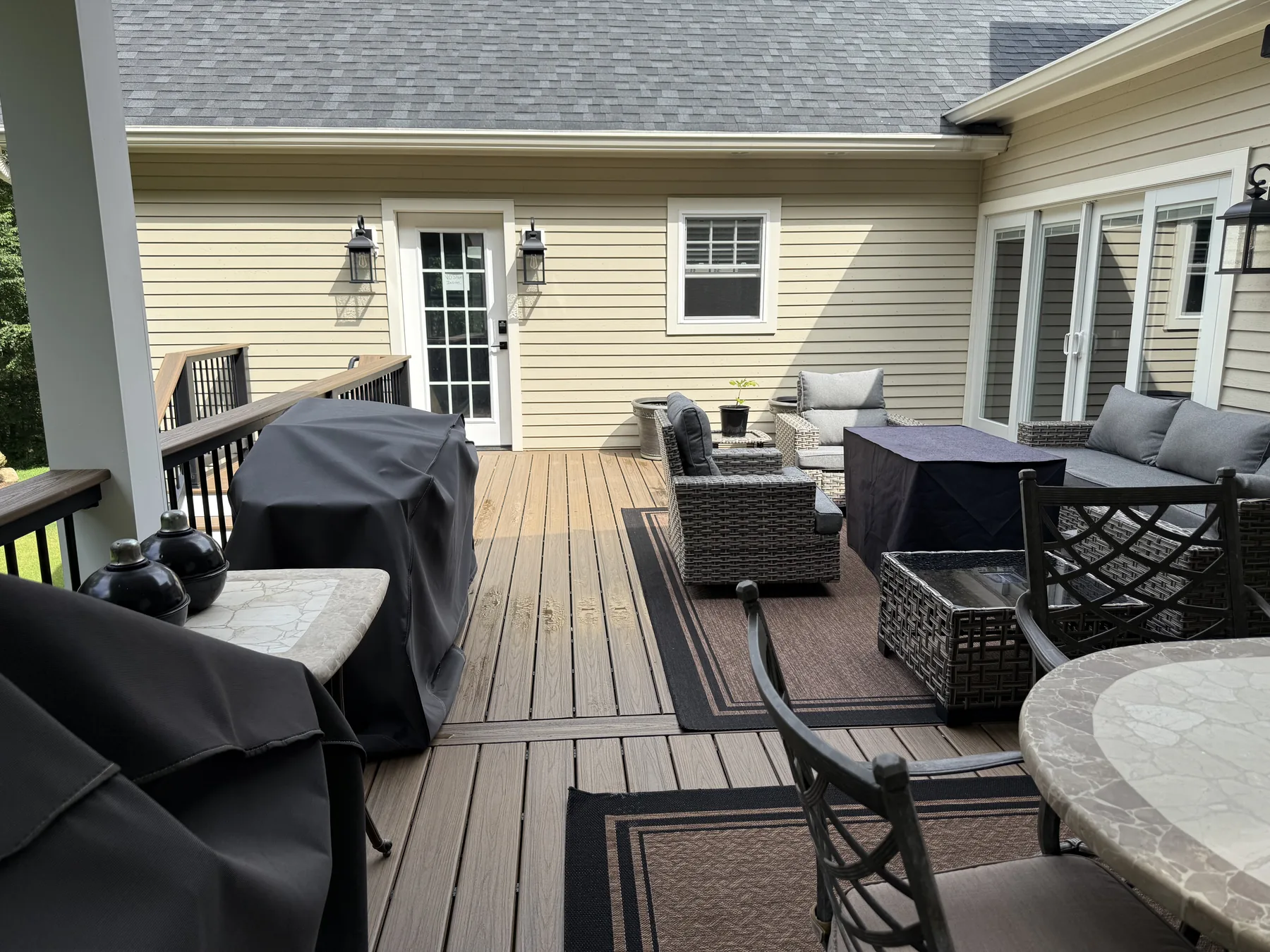 Covered deck with a timber ceiling, outdoor seating and black railings