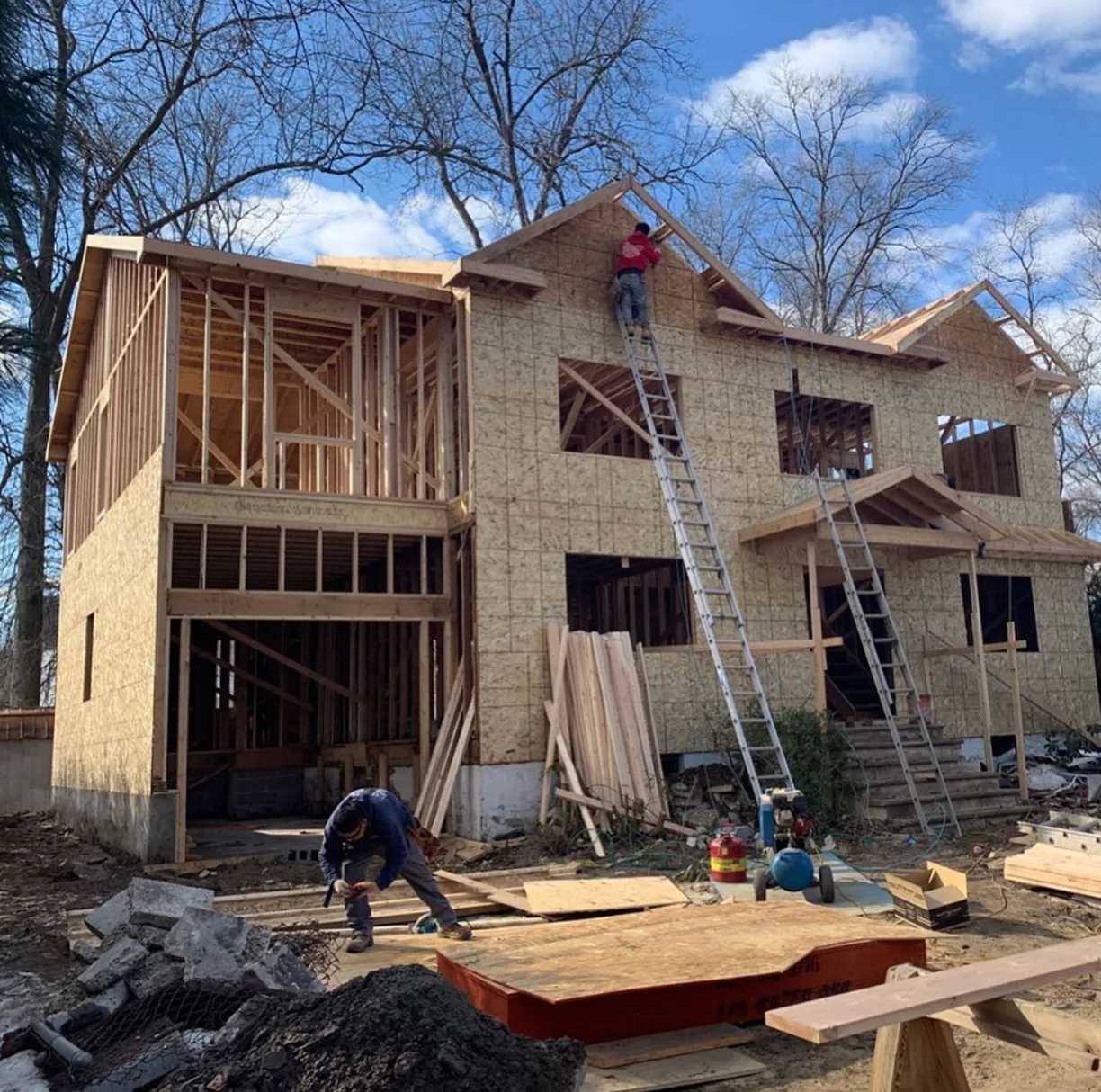 Carpenters working on the roof framing of a new build