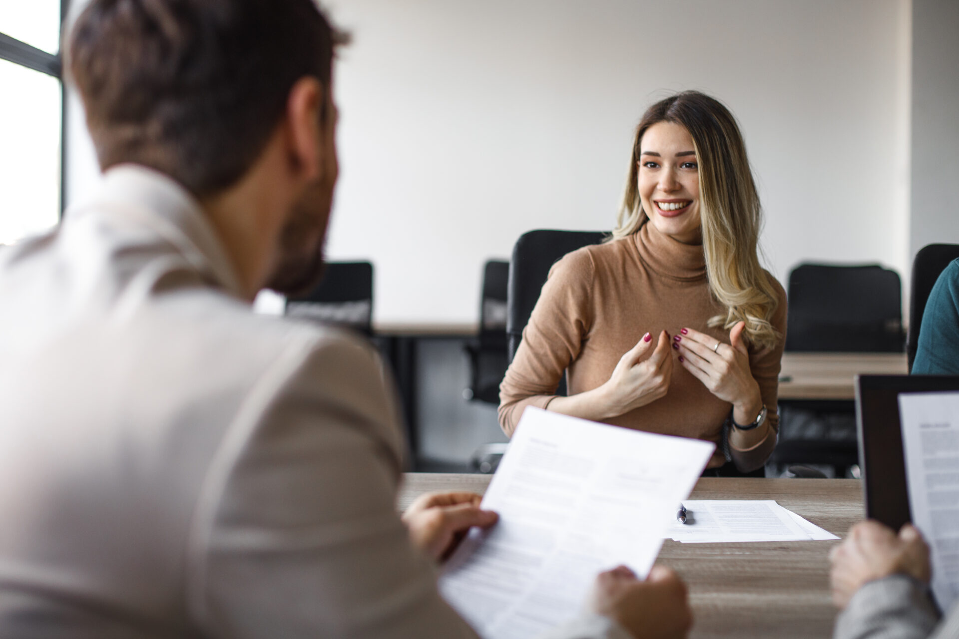 Happy female candidate on a job interview in the office.